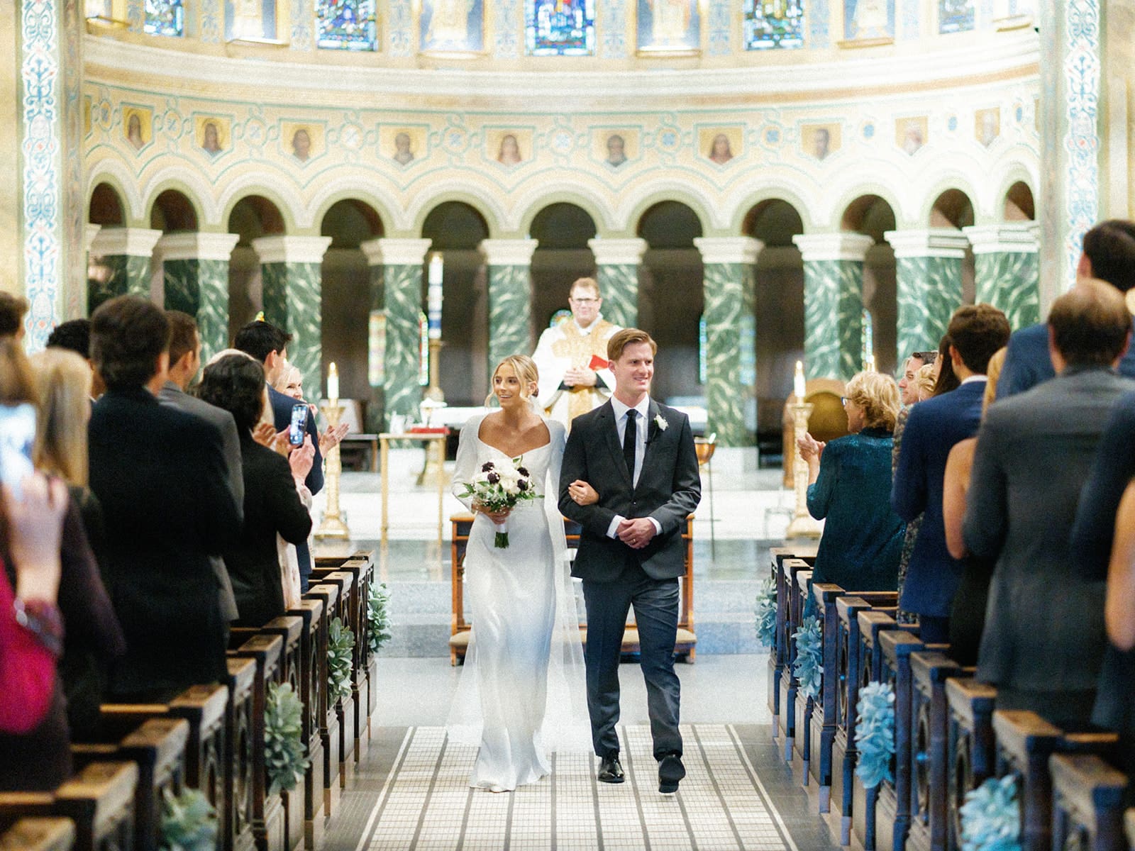 Bride and groom walking back down the aisle as husband and wife