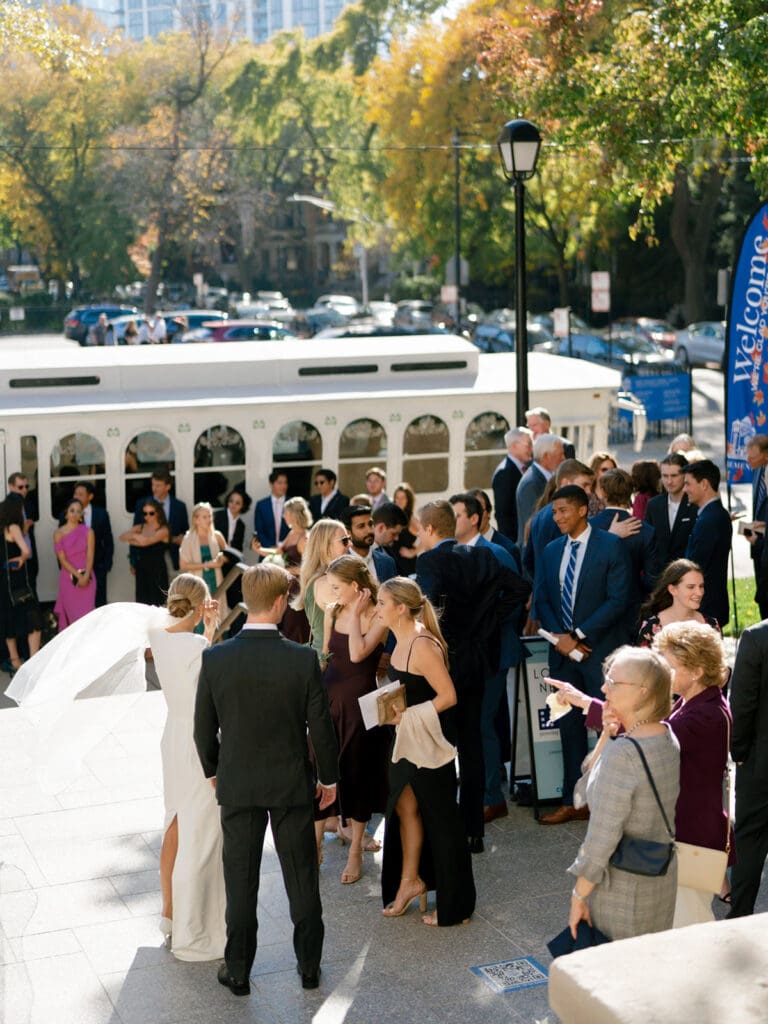Bride being greeted by their friends and family after their downtown Chicago wedding ceremony