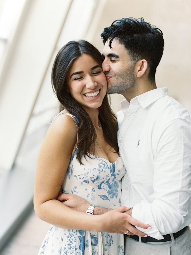 Man kissing his fiancé during their New York engagement photoshoot at The Met