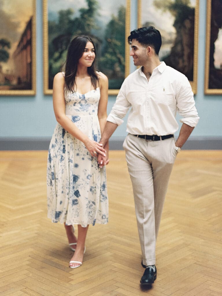 Couple holding hands and walking at The Met in NYC