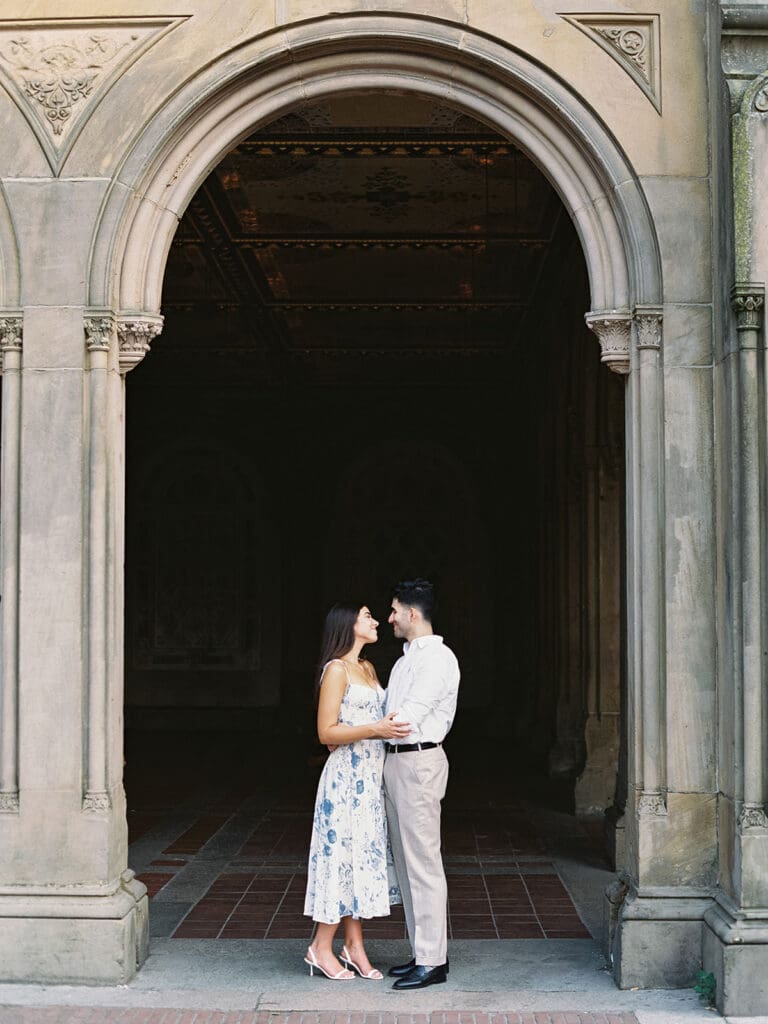 Couple posing at Bethesda Terrace for their Central Park Engagement Photos