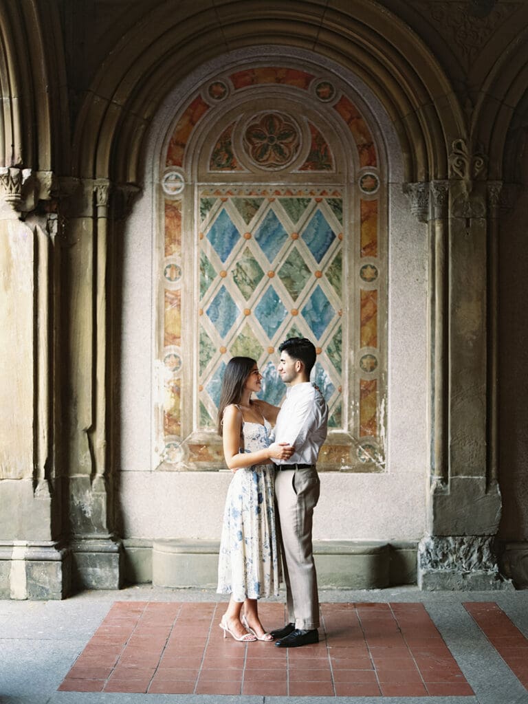 Couple posing at Bethesda Terrace for their Central Park engagement photos