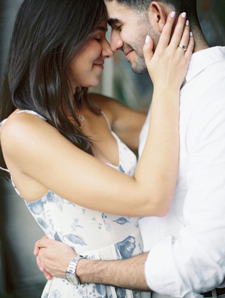 Man and woman posing for their New York City engagement shoot