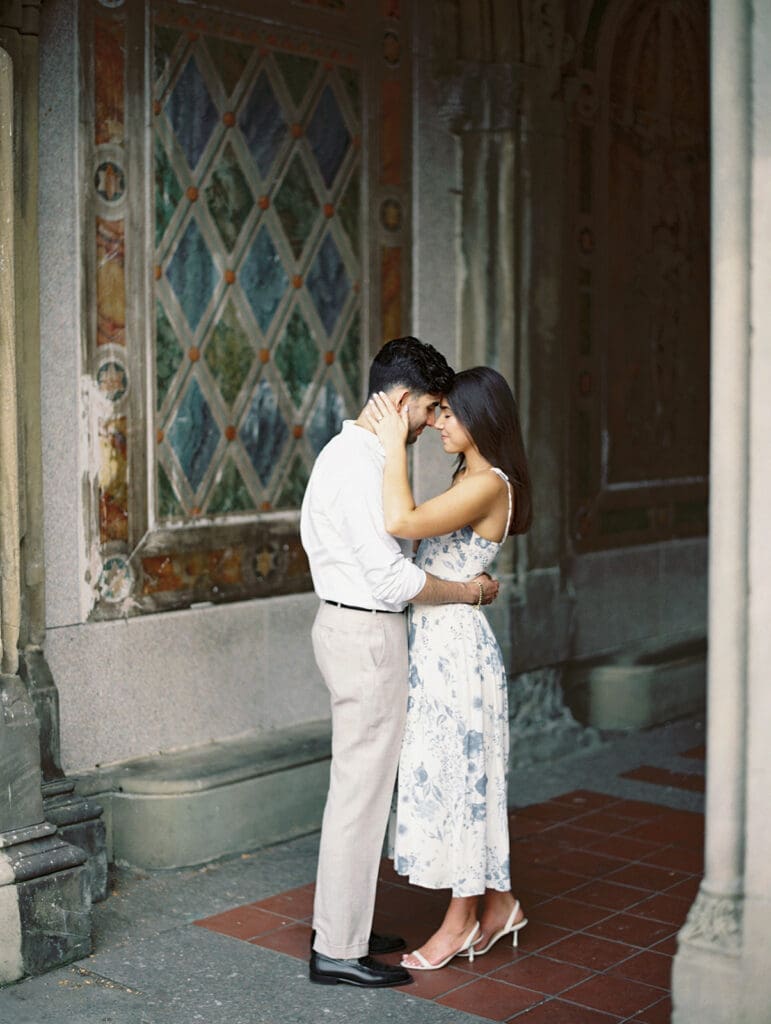 Couple posing at Bethesda Terrace for their Central Park engagement photos