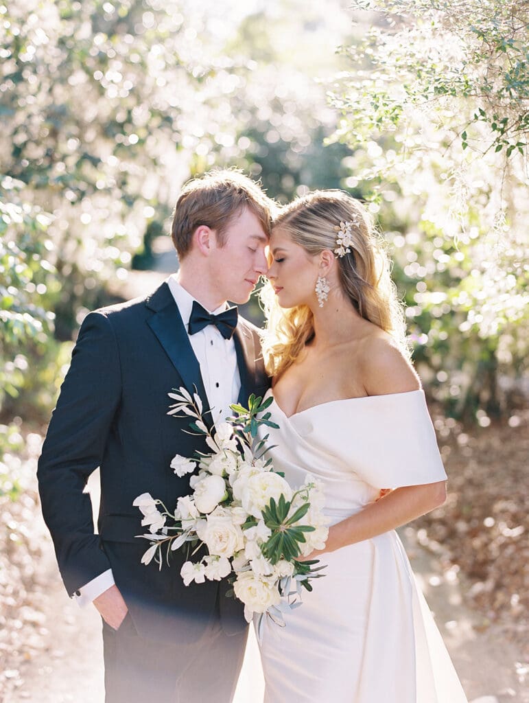 Bride and groom posing for their Middleton Place wedding portraits