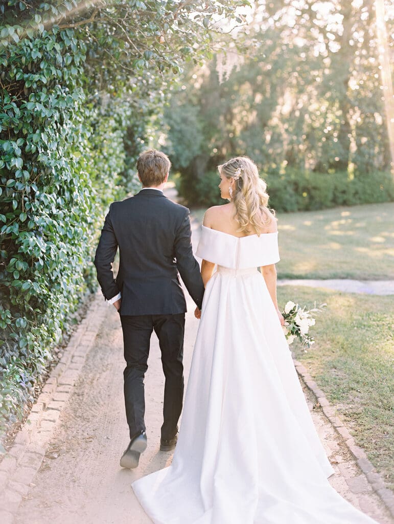 Bride and groom walking the grounds of Middleton Place wedding venue in Charleston, South Carolina