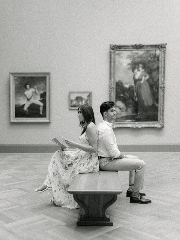 Couple admiring the art at The Met during their Central Park engagement photos