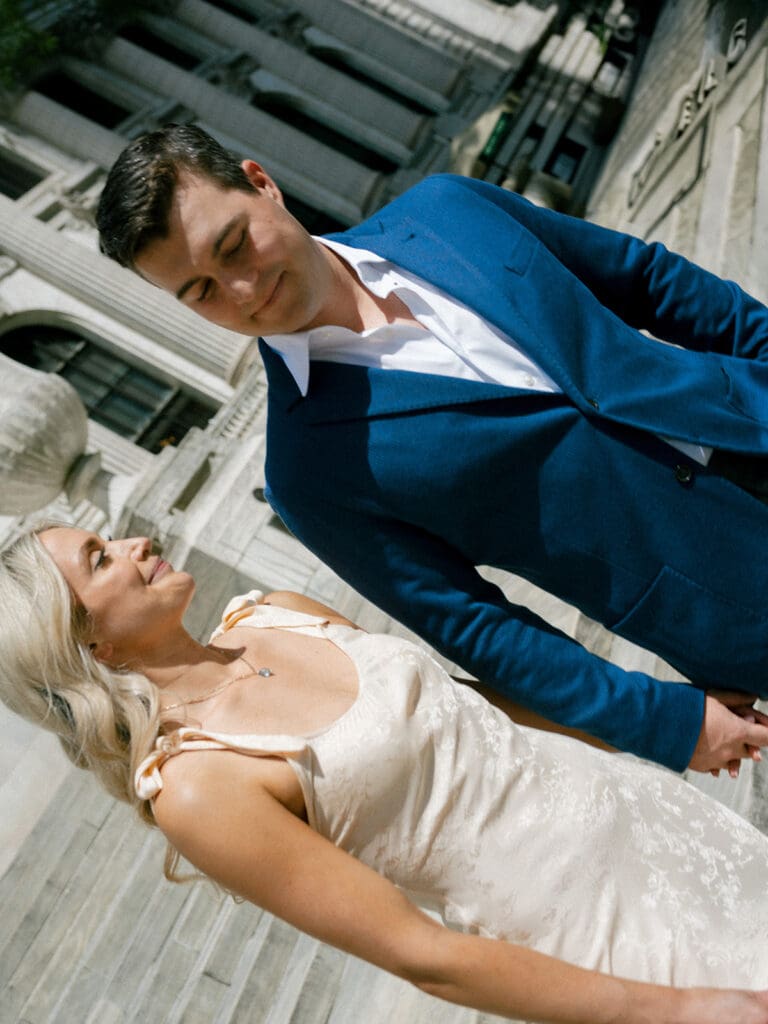 Couple walking down steps during their New York Public Library engagement photos
