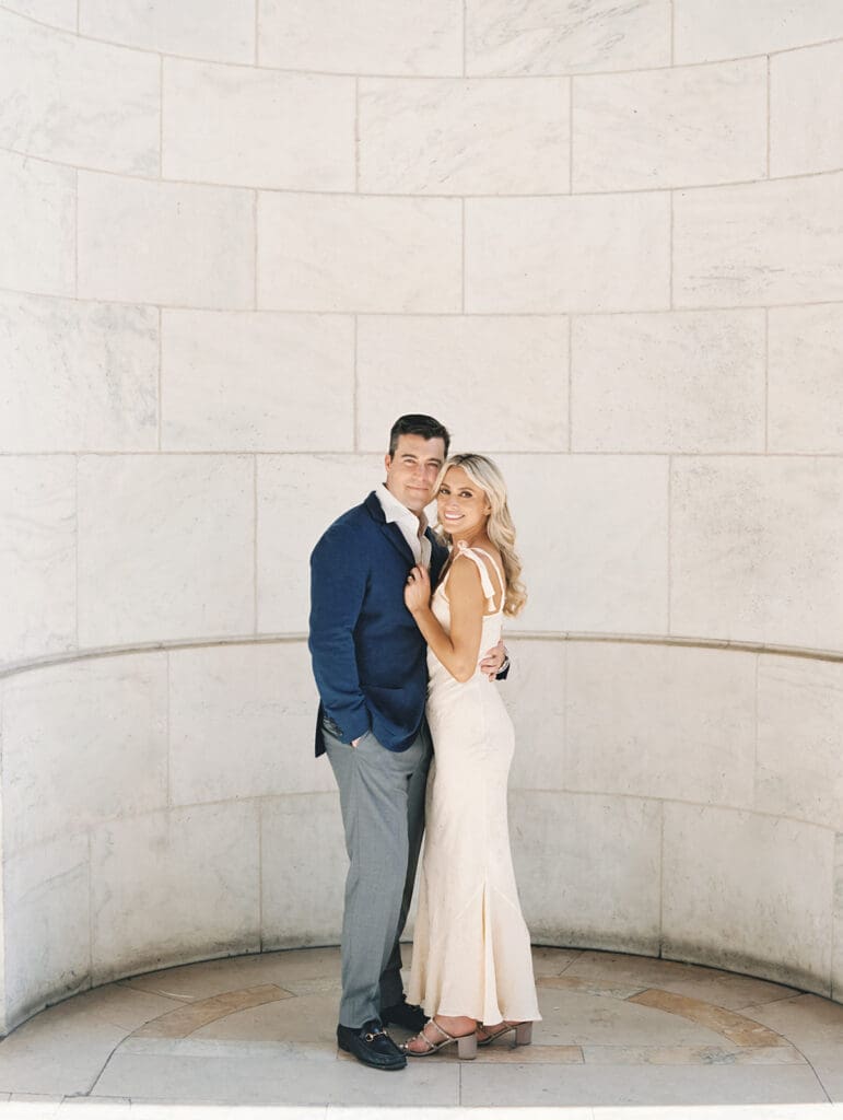 Couple posing for their New York Public Library engagement photos in New York City