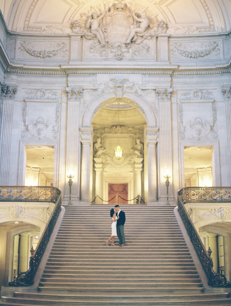 Couple kissing on the staircase for their San Francisco City Hall engagement photos