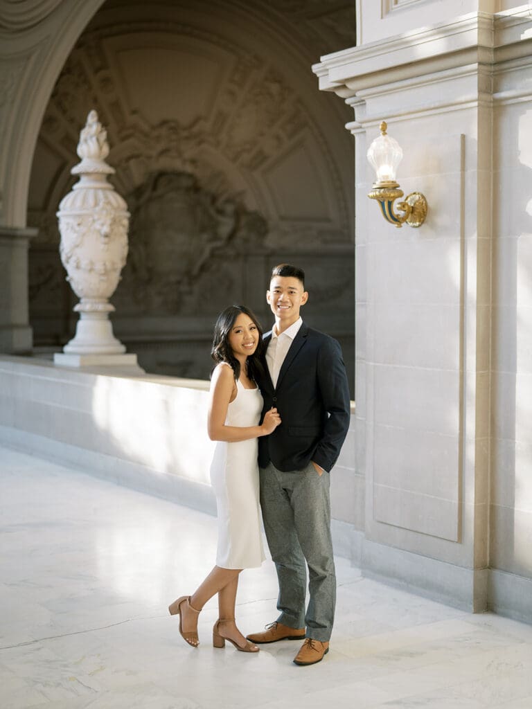 Couple posing together for their San Francisco engagement shoot at the city hall