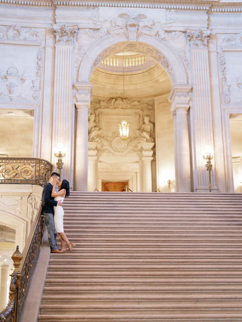 Couple kissing on the staircase for their San Francisco City Hall engagement photos