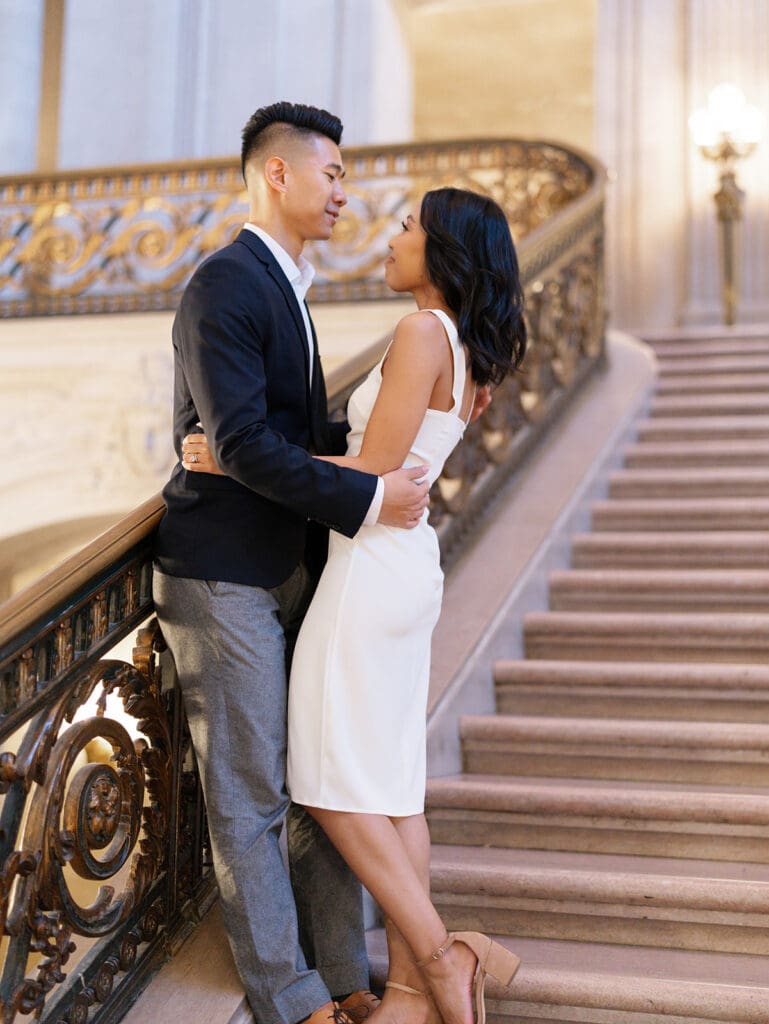 Couple holding each other during their San Francisco  City Hall engagement photos