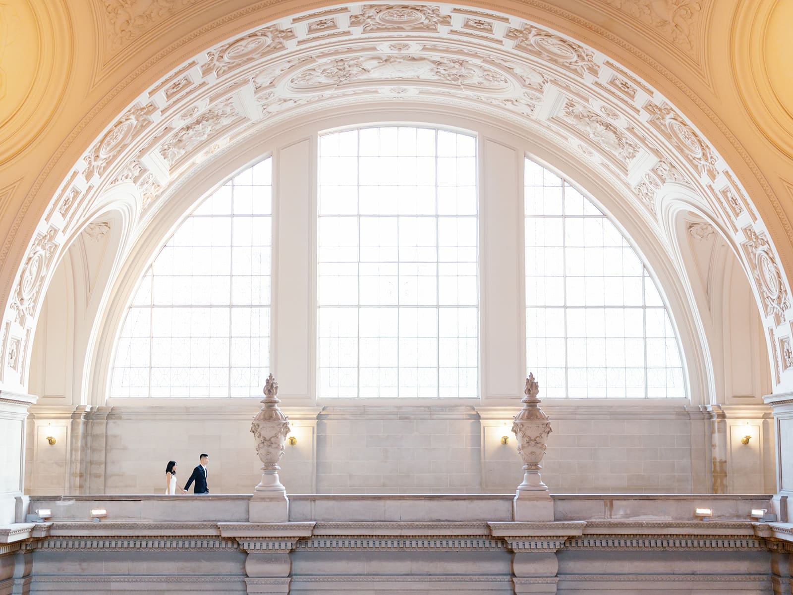 Far away shot of a couple walking at SF City Hall