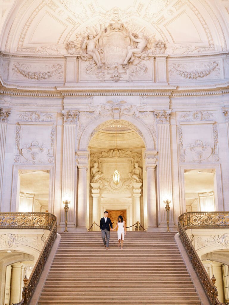 Couple walking down the staircase for their San Francisco City Hall engagement photos
