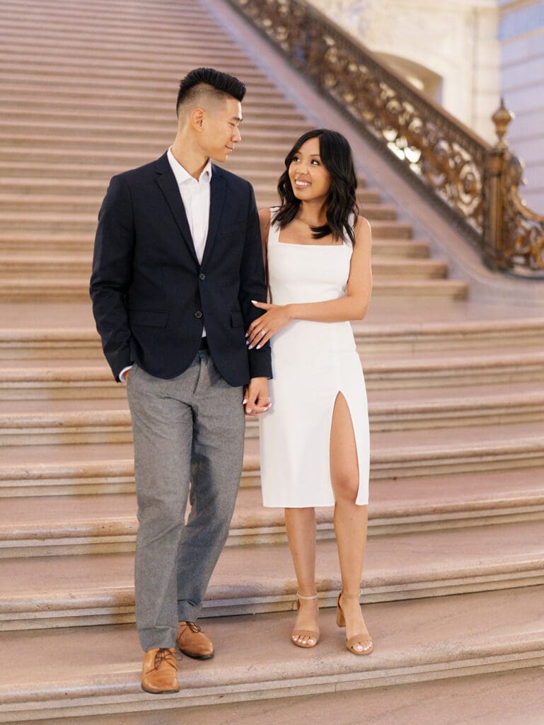 Couple walking down the staircase for their San Francisco City Hall engagement photos