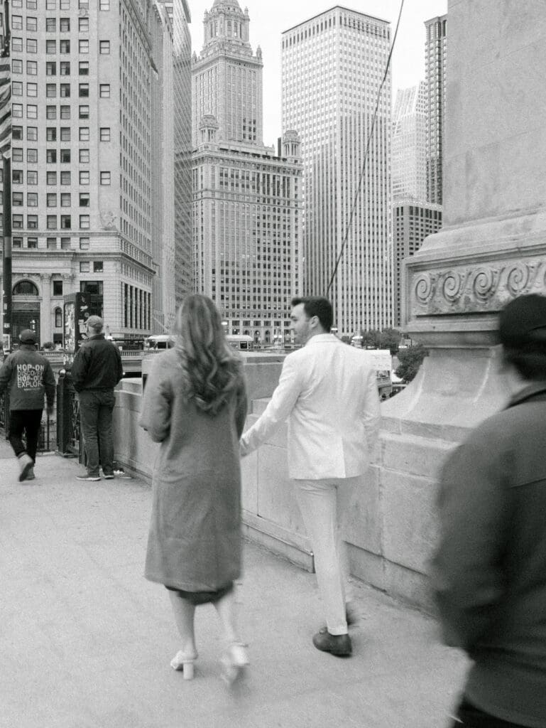 Chicago Riverwalk engagement photos walking through downtown Chicago