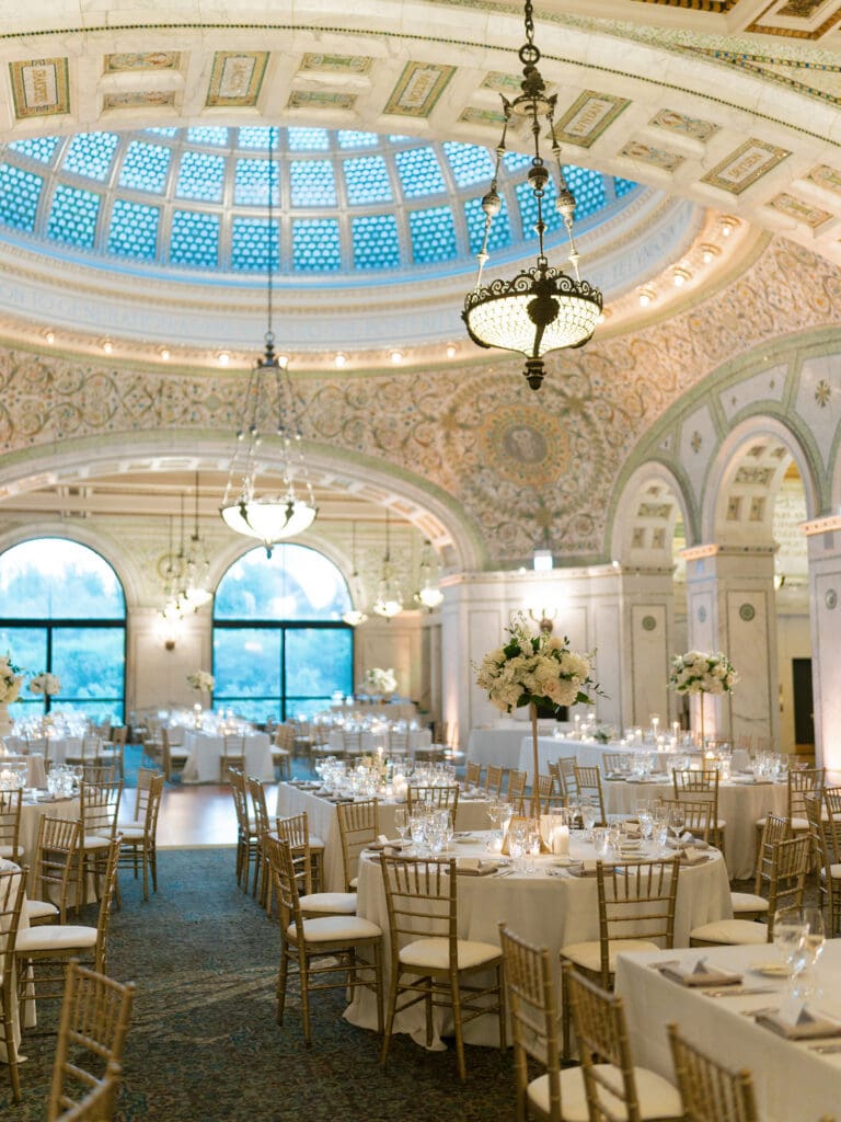 Elegant wedding reception inside the Chicago Cultural Center, a luxury Chicago wedding venue with ornate dome ceiling and chandeliers