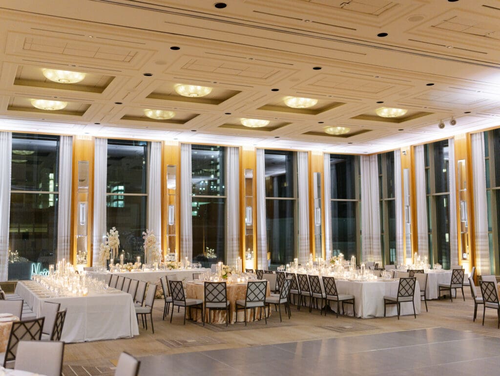 Luxury wedding reception at The Peninsula Chicago with candlelit tables, tall windows, and refined ballroom setting