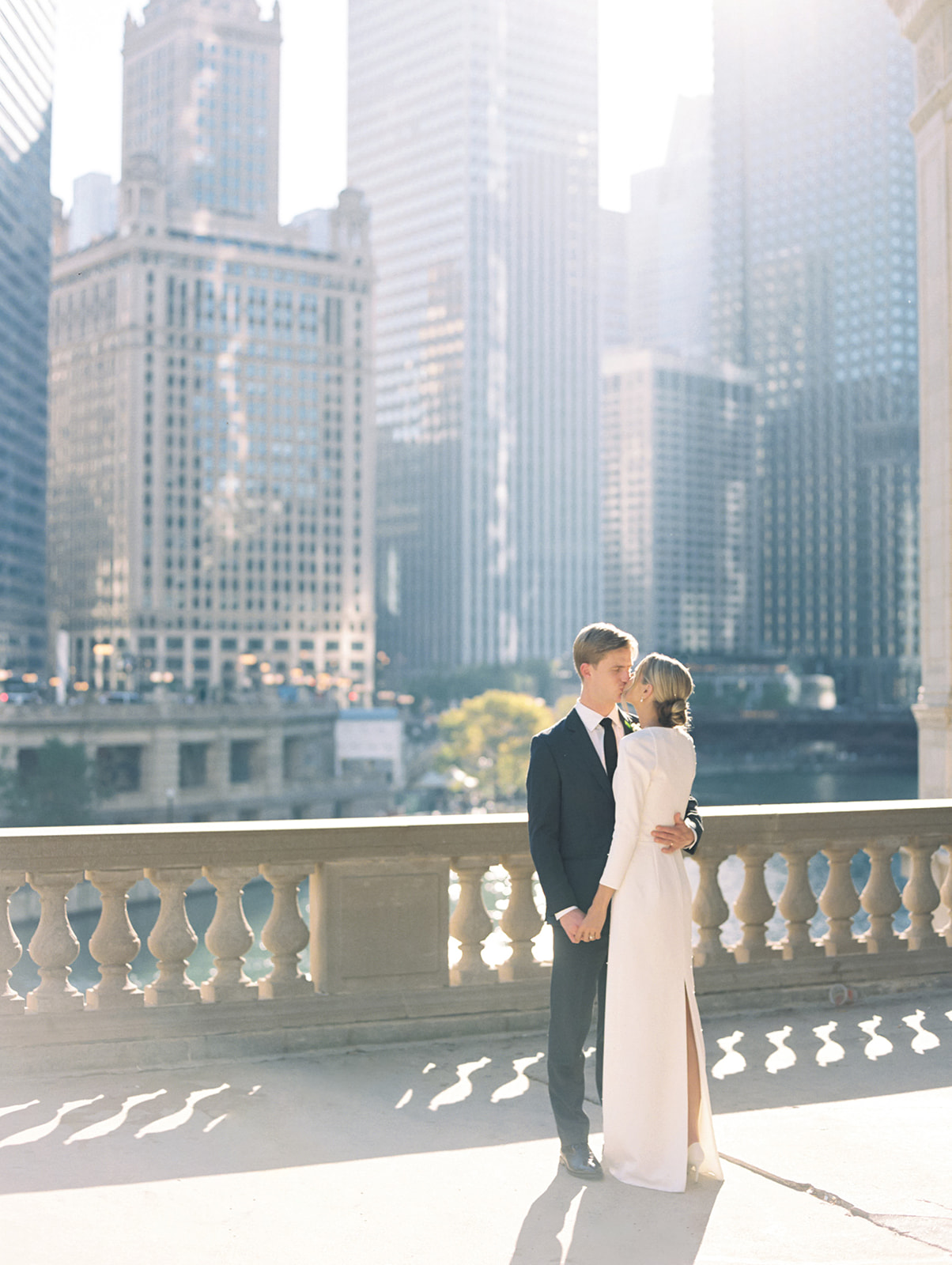 Bride and grooms fall downtown Chicago wedding portraits in front of The Wrigley Building