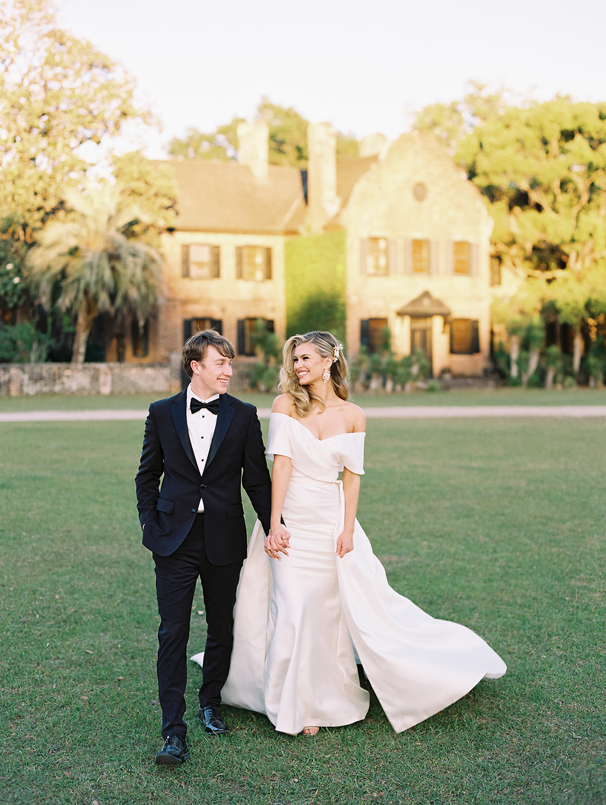 Bride and groom posing for their Middleton Place wedding portraits in Charleston, South Carolina